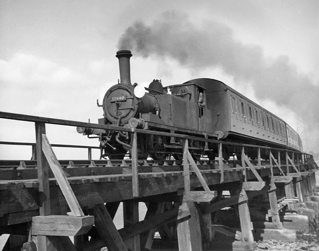 Photo of A1X 0-6-0 tank 32640 crossing the swing bridge on a Havant to Hayling Island train on 9th September 1962