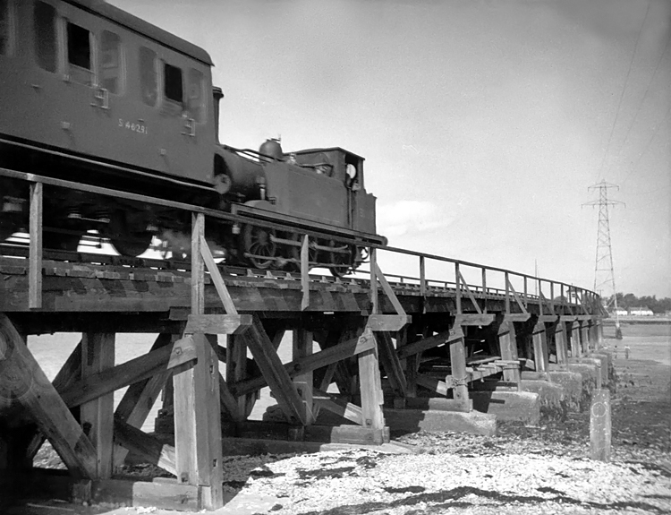 Photo of A1X 0-6-0 tank 32678 crossing the swing bridge on a Hayling Island to Havant train on 9th September 1962