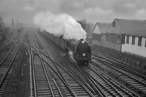 Photo of King Arthur Class 4-6-0 30798 on an up Salisbury to Waterloo train approaches Wimbledon on a very wet day in 1962