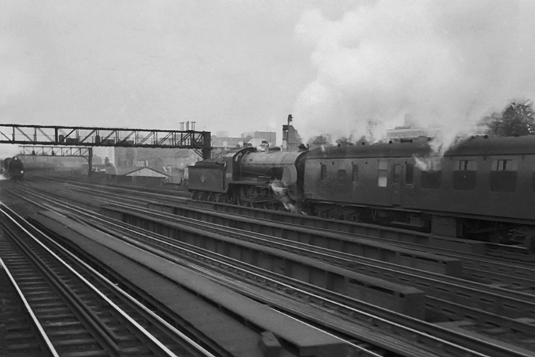 Possibly the last time a Lord Nelson and a King Arthur class met each other whilst hauling trains on the old LSWR. 30770 hauls an ecs train down beyond Vauxhall, meeting a Lord Nelson on an up Ocean Liner Boat train. Photographed from a 4-Sub unit heading between Vauxhall and Clapham Junction. 9th September 1962