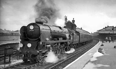 Photo of Bulleid West Sountry Class pacific number 34101, Hartland, leaving Salisbury with the Brighton to Plymouth train in the mid 1960s