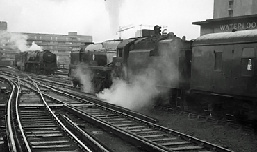Photo of Bulleid West Country Class pacific number 34010, Sidmouth, waits at the head of a departure from Waterloo as a Bulleid Bulleid Merchant Navy Class pacific reverses out light engine, mid 1960s