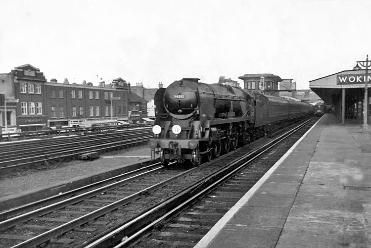 Photo of Bulleid West Country Class pacific number 34012, Launceston, working a train, that, from the headcode , is shown as a Waterloo or Nine Elms to Southampton Docks via East Putney, West through Woking in the mid 1960s