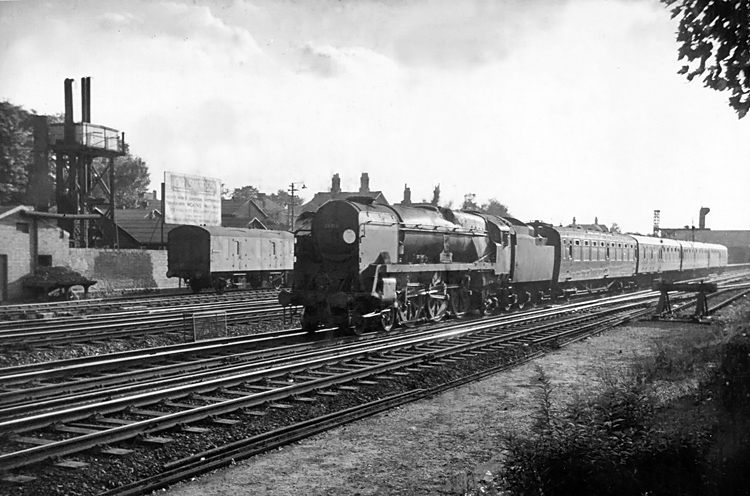 Photo of Bulleid West Country Class pacific number 34014, Budleigh Salterton, leaves Woking for London, Waterloo with a local train from Basingstoke in the mid 1960s