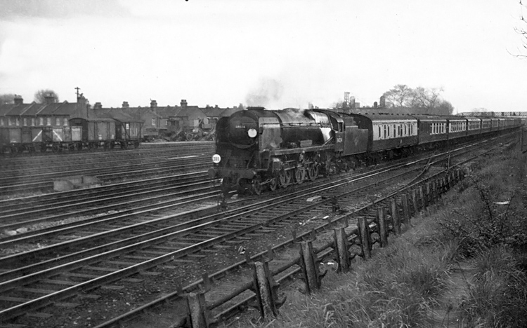 Photo of Bulleid West Country Class pacific number 34024, Tamar Valley, passing Wimbledon with the 16.28 Bournemouth West to London, Waterloo the Bournemouth Belle all Pullman car train in the mid 1960s