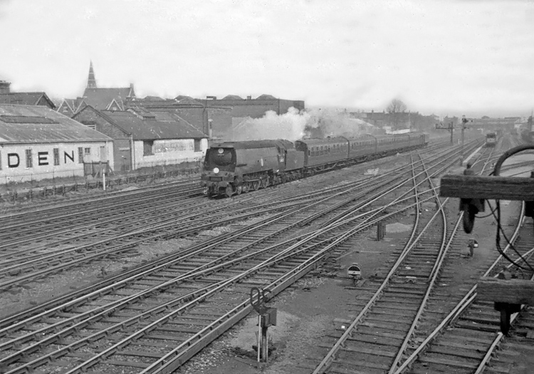 Photo of original Bulleid Battle of Britain Class pacific number 34051, Winston Churchill, just after passing through Wimbledon station with a train to Salisbury from London, Waterloo, in the mid 1960s
