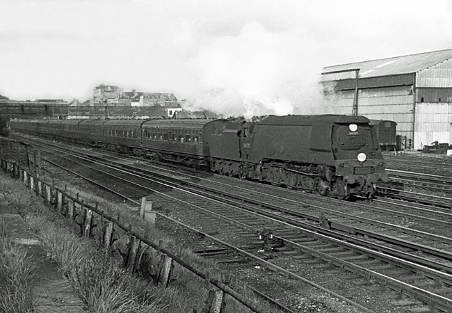 Photo of original Bulleid Battle of Britain Class pacific number 34057, Biggin Hill, just after passing Wimbledon station with a train from London, Waterloo to the West Country via Salisbury in the mid 1960s