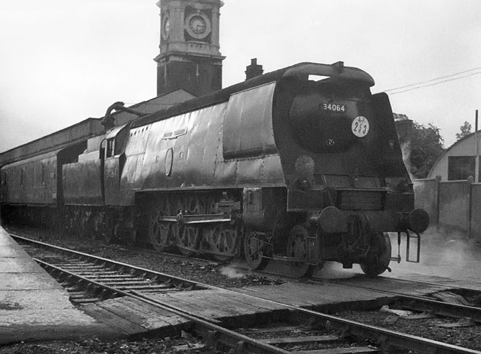 Photo of original Bulleid Battle of Britain Class pacific number 34064, Fighter Command, waits at Southampton whilst heading a Bournemouth to London, Waterloo train in the mid 1960s