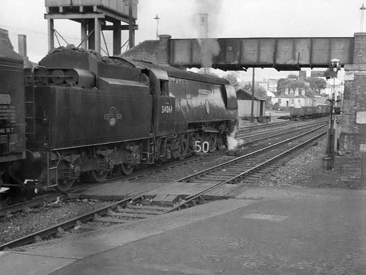 Photo of original Bulleid Battle of Britain Class pacific number 34064, Fighter Command, waits at Southampton whilst heading a Bournemouth to London, Waterloo train in the mid 1960s