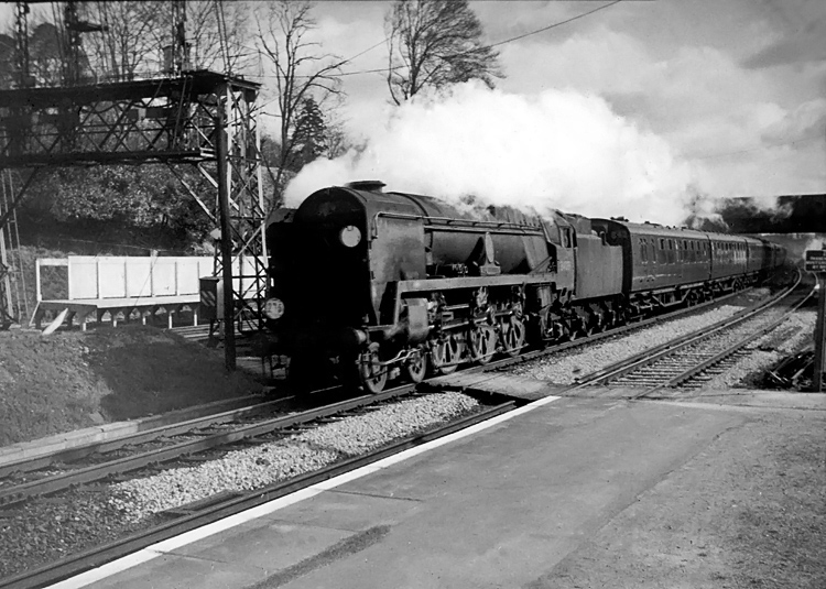 Photo of Bulleid Battle of Britain Class pacific number 34088, 213 Squadron, passing Farnborough station on a London, Waterloo to Bournemouth train in the mid 1960s
