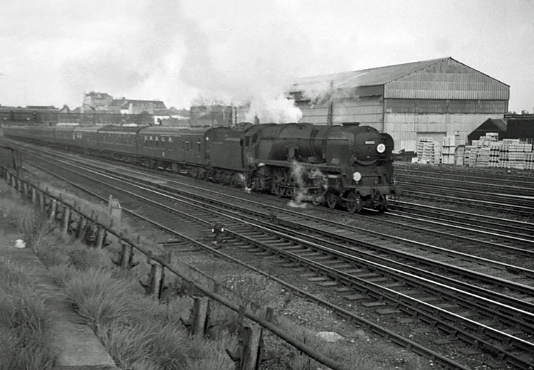 Photo of Bulleid Battle of Britain Class pacific number 34090, Sir Eustace Missenden, heading a London, Waterloo to Bournemouth train past Wimbledon in the mid 1960s