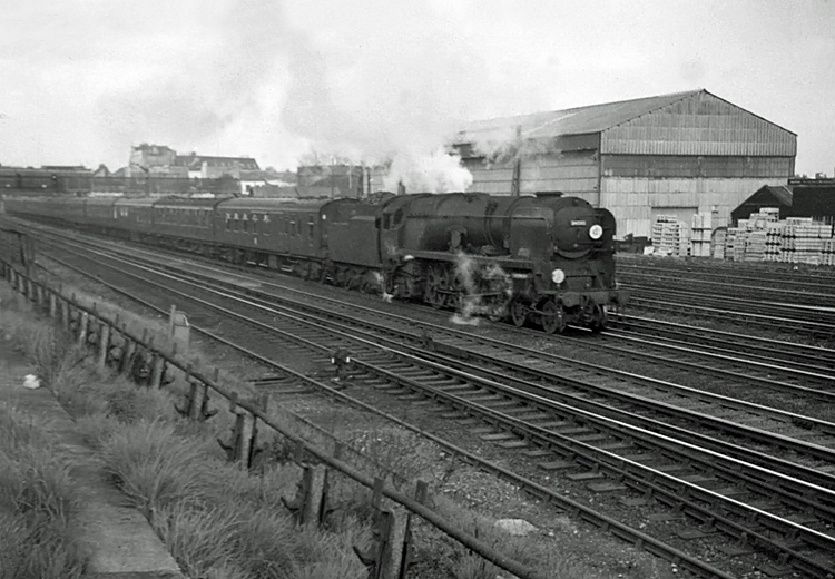 Photo of Bulleid Battle of Britain Class pacific number 34090, Sir Eustace Missenden, heading a London, Waterloo to Bournemouth train past Wimbledon in the mid 1960s