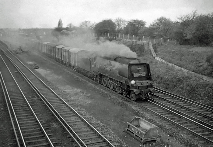 Photo of original Bulleid West Country  Class pacific number 34099, Lynmouth heading an up van train from Southampton Docks to London, NIne Elms, through New Malden in the mid 1960s
