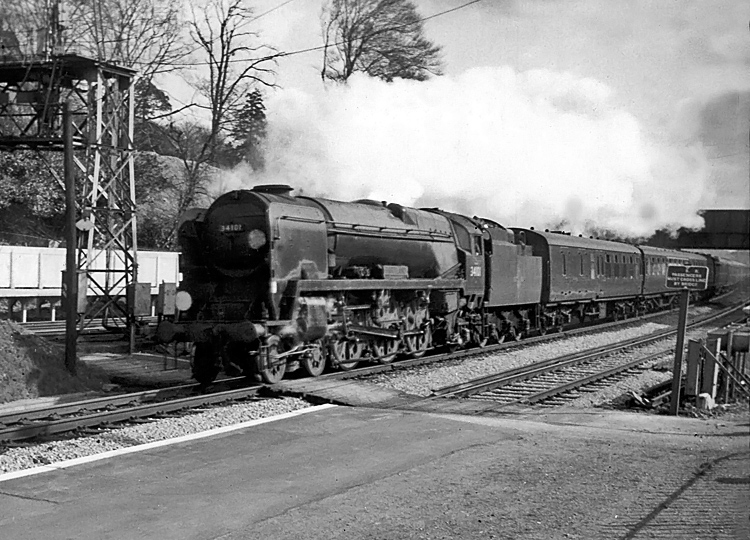 Photo of Bulleid West Country  Class pacific number 34101, Hartland, powers through Farnborough with a London, Waterloo to Bournemouth train in the mid 1960s