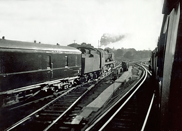 Photo of Bulleid West Country  Class pacific number 34104, Bere Alston on a London, Waterloo to Salisbury train leaves Woking and turns onto the down slow line just as another Bulleid light pacific leaves the bay platform heading for Guildford ona parcels train in the mid 1960s