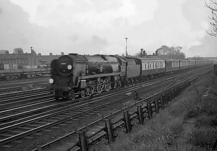 Photo of Bulleid Merchant Navy  Class pacific number 35007, Aberdeen Commonwealth, passing Wimbledon with the 16.28 Bournemouth West to London, Waterloo, the up Bournemouth Belle pullman car train in the mid 1960s