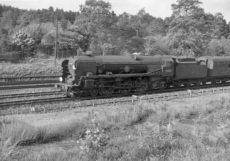 Photo of Bulleid Merchant Navy  Class pacific number 35007, Aberdeen Commonwealth, on the slow line between Pirbight Junction and Milepost 31when heading a London, Waterloo to Bournemouth train in the mid 1960s