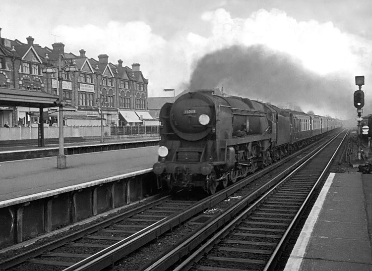 Photo of Bulleid Merchant Navy  Class pacific number 35008, Orient Line, thunders through Woking with the 12.30 Waterloo to Bournemouth West, the down Bournemouth Belle pullman car train in the mid 1960s