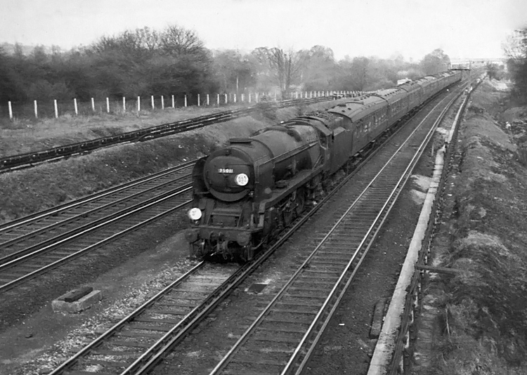 Photo of Bulleid Merchant Navy  Class pacific number 35011, General Steam Navigation, on a down London, Waterloo to Bournemouth train between Raynes Park and New Malden in the mid 1960s
