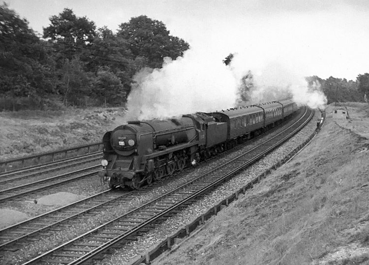 Photo of Bulleid Merchant Navy  Class pacific number 35021, New Zealand Line, heading a London, Waterloo to Bournemouth train around the curve between Pirbight Junction and Milepost 31 in the mid 1960s