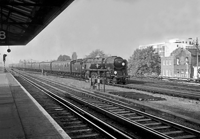 Photo of Bulleid Merchant Navy  Class pacific number 35026, Lamport & Holt Line heading into Woking station with a Bournemouth to London, Waterloo train in the mid 1960s