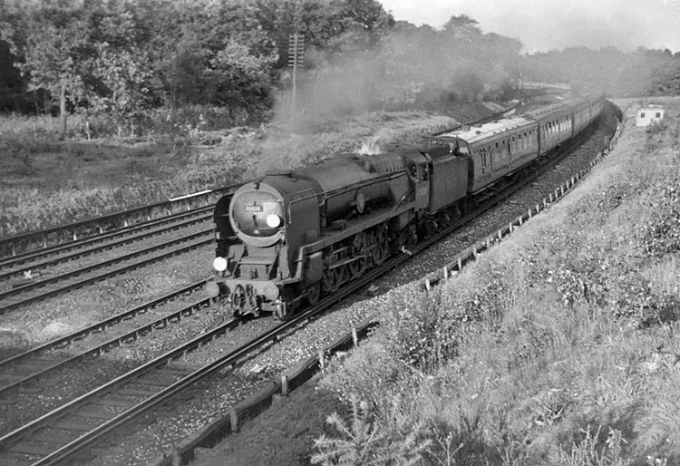 Photo of Bulleid Merchant Navy  Class pacific number 35028, Clan LIne, on the slow line climbing to the summit at Milepost 31 soon after Pirbight Junction heading a London, Waterloo to Bournemouth train in the mid 1960s