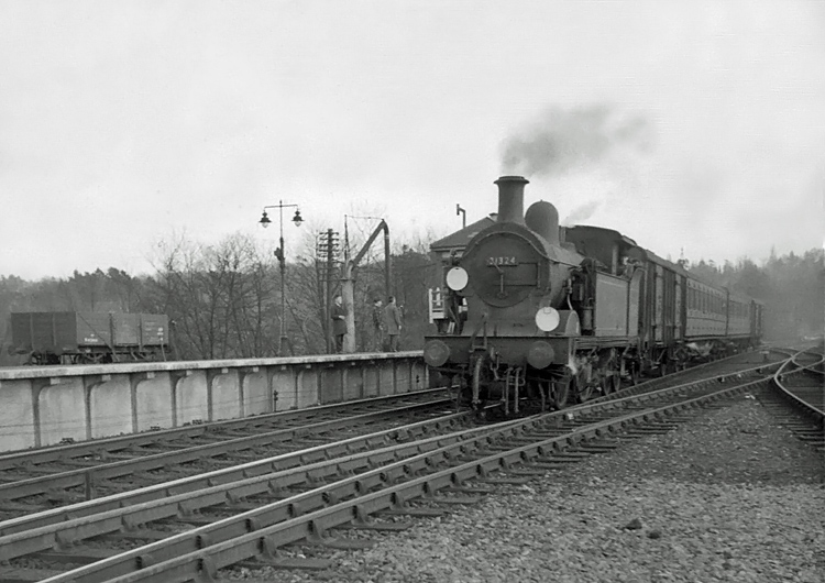 Photo of H class 0-4-4 tank loco number 31324 arriving at Oxted in April 1962 with a train from Tunbridge Wells West