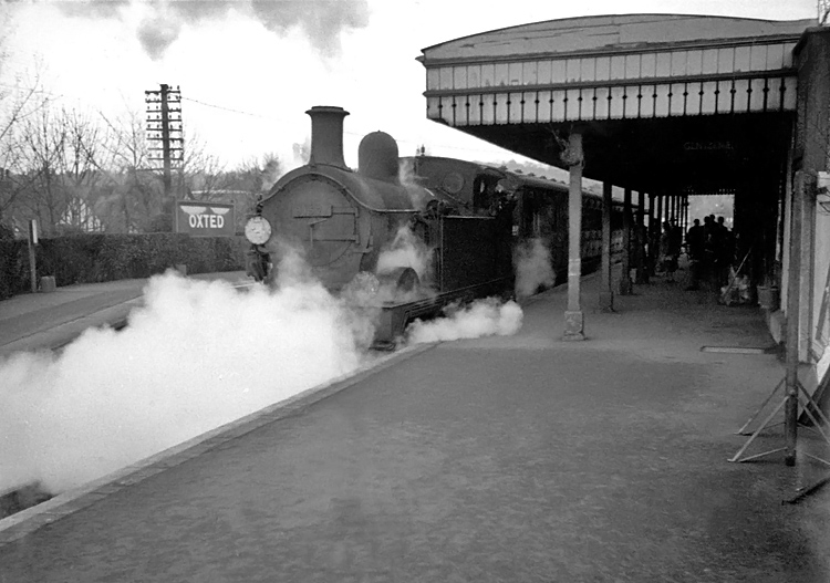 Photo of H class 0-4-4 tank loco number 31521 in the up platform at Oxted after arriving from Tunbridge Wells West, circa April 1962