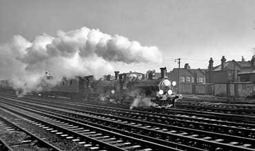Photo of 0298 Class 2-4-0  well tank locos 30585 and 30587 Leaving Wimbledon in December 1962