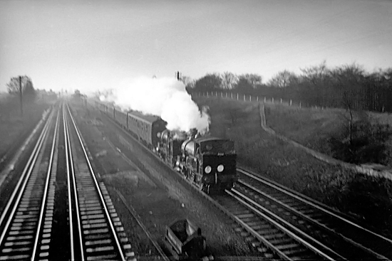 Photo of 0298 Class 2-4-0  well tank locos 30585 and 30587 heading through New Malden towards Wimbledon in December 1962