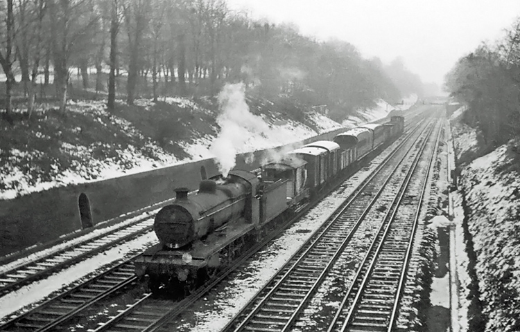Photo of  a K class 2-6-0 on a mixed goods train approaching East Croydon during winter 1961/62