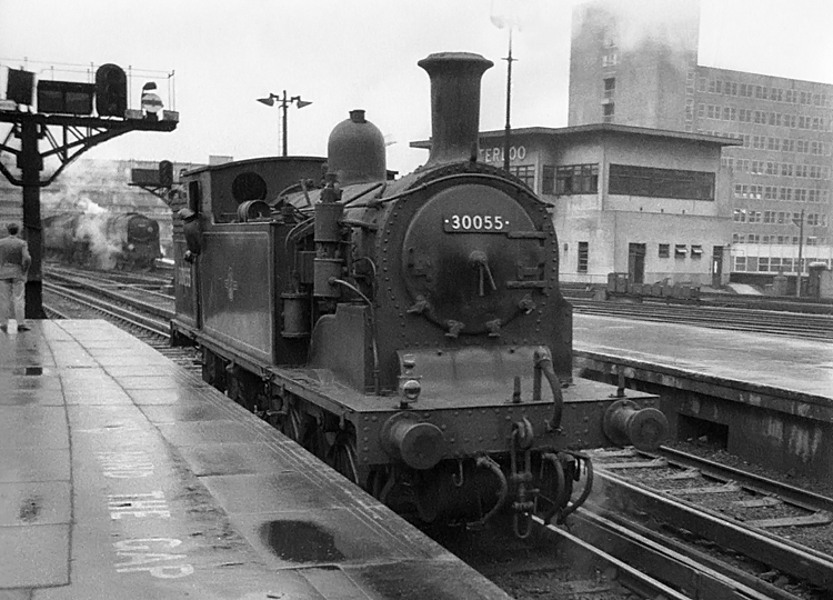 Photo of M7 Class 0-4-4 tank loco waiting at plartform end at Waterloo, as a Bulleid pacific enters with an up train from the Bournemouth line. 1962