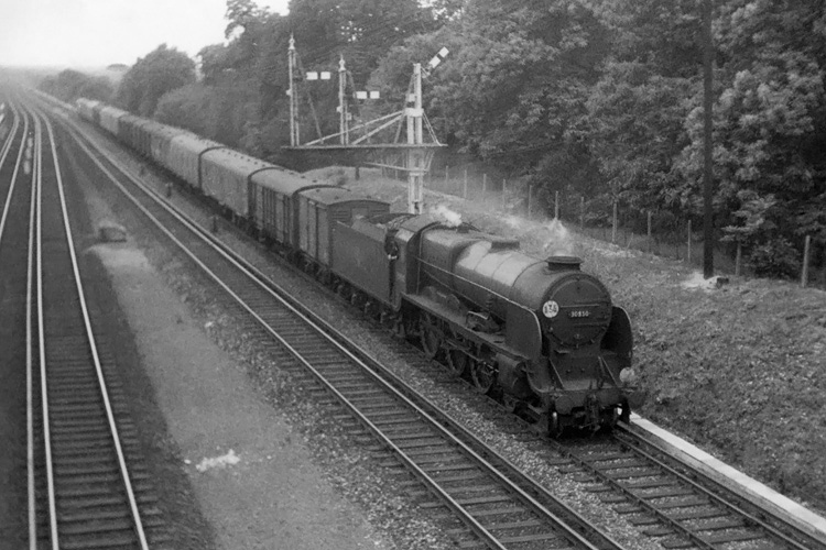 1962 photo of Lord Nelson Class 30850 on up parcels train near Weybridge