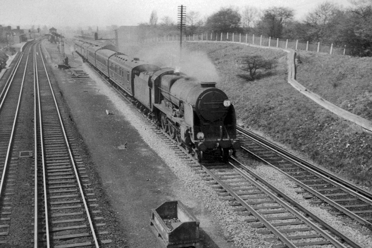 Easter Monday 1962 photo of Lord Nelson Class 30861 on a Bournemouth - Waterloo semi fast train passing New Malden