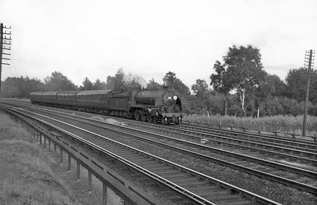 Photo of  Urie S15 class 4-6-0 number 30515 climbing up from Pirbight Junction towards Milepost 31 with the 17.54 Waterloo- Basingstoke local train on 25th August 1962