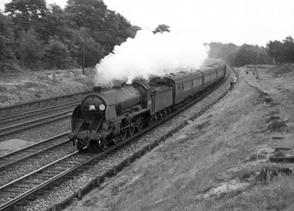 Photo of  Urie S15 class 4-6-0 number 30508 climbing up from Pirbight Junction towards Milepost 31 with a Waterloo- Basingstoke empty stock train at 19.45 on 25th August 1962