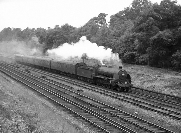 Photo of  Urie S15 class 4-6-0 number 30501on an up local train from Salisbury due at Waterloo 17.36, between Milepost 31 and Pirbight Junction on 11th August 1962