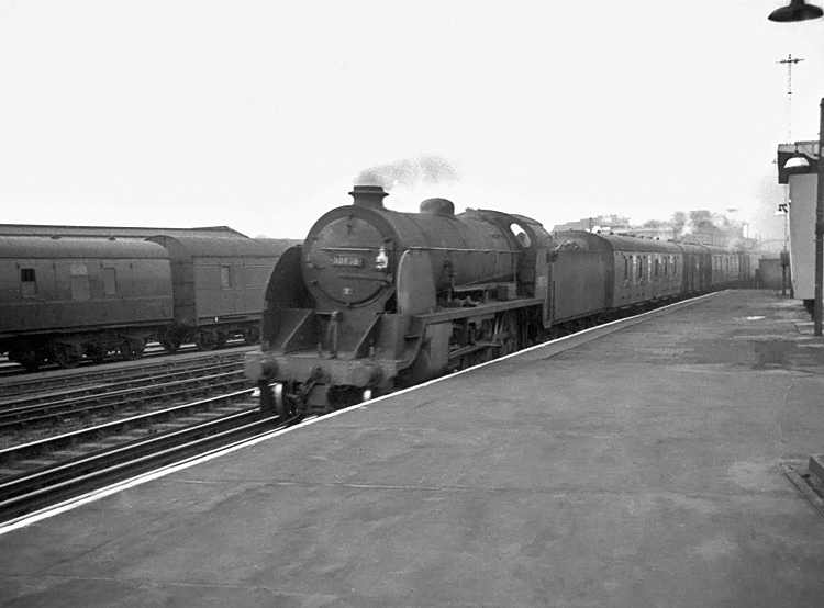 Photo of Maunsell S15 class 4-6-0 number 30838 heading a down parcels train through Clapham Junction in 1962-1963. Probably the 19.02 van train