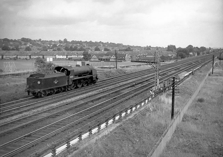 Photo of Maunsell S15 class 4-6-0 number 30838 heads light engine in the up direction between New Malden and Raynes Park in 1962-1963