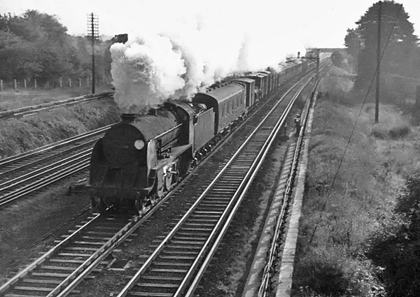 Photo of Maunsell S15 class 4-6-0 number 30846 heading a train of mixed formation down between Raynes Park and New Malden on 1962-1963