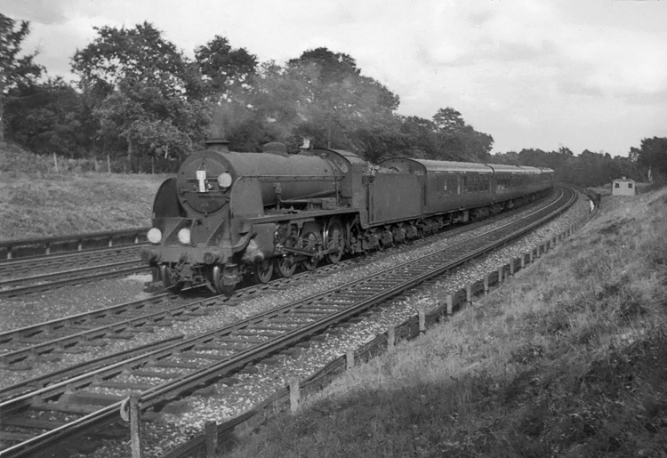 Photo of Maunsell S15 class 4-6-0 number 30845 with an incorrectly head coded Ocean Liner Express,  climbing from Pirbight Junction to Milepost 31 at 16.47 on 11th August 1962