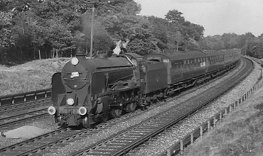 Photo of a  Schools Class 4-4-0 on a down Salisbury train between Pirbight Junction and Milepost 31 in summer 1962