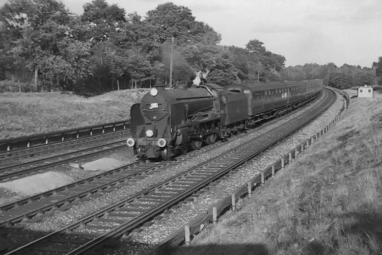 Photo of Schools Class 4-4-0 30925 on the 17.00 Waterloo to Salisbury train between Pirbight Junction and Milepost 31 on 25th August 1962. The loco was possibly deputising for a Bulleid, and was going well, climbing to the MP 31 summit at a speed estimated to be in the upper 50s