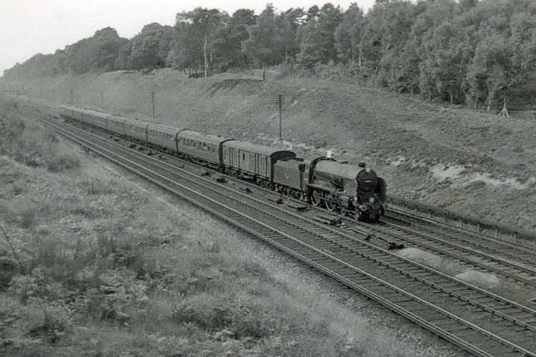 Photo of Schools Class 4-4-0 30925 on an the 08.30 Plymouth to Waterloo train on 2nd September 1962. The train had a 94 minute non stop schedule from Salisbury to Waterloo, and was estimated to be travelling at around 75 mph. Photo taken between Milepost 31 and  Pirbight Junction
