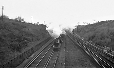 Photo of T9 class 4-4-0 number 30117 and E1 class 4-4-0 number 31019 heading the Ashford and Eastleigh Works Railtour towards Elmstead Woods tunnel on 5th April 1961