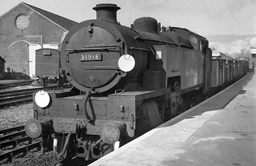 Photo of W Class 2-6-4 tank loco 31918 on a goods train somewhere on the Oxted line South of Croydon. Spring 1962