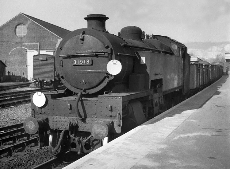 Photo of W Class 2-6-4 tank loco 31918 on a goods train somewhere on the Oxted line South of Croydon. Spring 1962